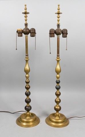 53	Pair of Chippendale Style Brass Lamps	Two Chippendale Style brass lamps. American, early 20th Century. Brass lamps with bun and teardrop stands. Wear consistent with age. From the Salmagundi Club, the oldest artists club in America. Lamps have not been tested. 34" H
