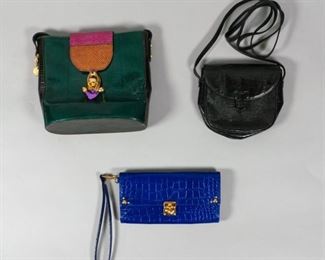 78	3 Exotic Leather Bags	A Samantha Thavasa Petit Choice purple clutch with gold hardware and heart lock. 8" L x 4 1/2" W. A Jacquese Saint Just bucket bag with three panel leather and beaded clasp. 8" L x 10" W. A Luc Benoit small black cross body pouch. 7 1/2" L x 6 1/2" W. From the collection of the Salmagundi Club.
