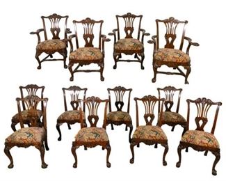 246	A Set of Twelve George III Style Irish Chairs	Set of twelve George III Style Irish carved chairs. 19th Century or earlier. Bow shaped top rail with centered acanthus leaf and "C" scroll motif flanked with corners embellished with scalloped shells raised over pierced splat with acanthus and "C" scroll detail, the outscrolling arms with intricately carved terminals of phoenix motif over supports with acanthus detail raised over shaped apron with centered carved scalloped shell flanked with acanthus detail, supported on cabriole leg with scalloped shell on knee joined with H stretcher, with scallop shell detail terminating on ball-and-claw foot. Upholstered floral cushions are removable and were most likely made and added to the chairs in the Mid 20th Century. Chairs were originally retailed by Michael Butler, a collector and restorer of antique furniture and collectibles. They operated at three different locations from 1877 to 1912. The original label is still intact on one chair and