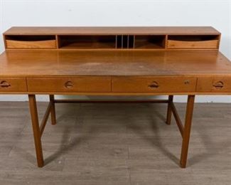 279	Peter Lovig Danish Modern Flip-Top Desk	Peter Lovig (Danish, 1915-1989.) Danish Modern flip-top desk. Danish, Mid 20th Century. Teak, four drawers and flip-top storage with divided compartments and two removable trays. Original key is included. Lovig Dansk designer stamp to underside. Scratches and water stains to top, wood is nicked on top left part of flip-top. Back stretcher is loose. Closed: 34" H x 64" L x 28" D Open: 29" H x 64" L x 38" D
