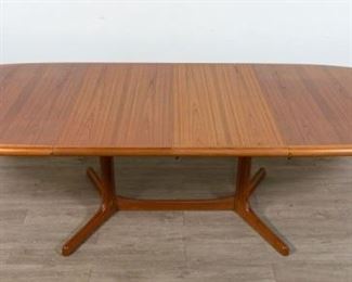 281	Danish Modern Dining Table	Danish Modern dining table produced by Dyrlund. Danish, mid 20th Century. Table extends out and fits two leaves. Dyrlund manufacturing labels, "MADE IN DENMARK" and "85150". Some small scratches on legs. With leaves: 29" H x 104" L x 41 1/2" D Without leaves: 29" H x 65" L x 41 1/2" D
