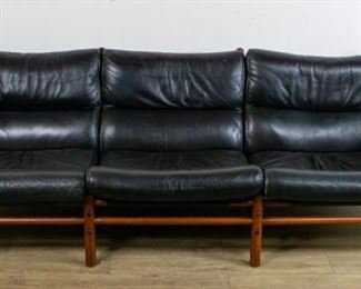 287	Arne Norell Kontiki Sofa Danish Design	Arne Norell (Sweden, 1917-1971). Mid-century modern beechwood and distressed black leather. Norell label. Wear and creases to leather, wood with wear consistent with age. 29 1/2" x 90" x 35" "Roman and Williams Buildings & Interiors Things We Made" Pages 180-182
