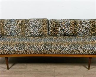 298	Mid Century Modern Leopard Print Couch	Mid Century Modern leopard print couch. Yugoslavian, Mid 20th Century. Teak body, wire recess, 3 leopard print cushions. "MADE IN YUGOSLAVIA" stenciled underneath left arm. Some wear to cushions. 25" H x 77" L x 28" D
