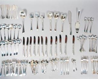 356	Anton Michelsen Sterling Silver Flatware	A. Michelsen (Denmark 1841-1985) 99 Piece sterling silver flatware set. Marked "A Michelsen Copenhagen Sterling Denmark". 24 teaspoons, 16 salad forks,12 butter knives, 12 soup spoons, 12 dinner forks, 12 iced tea spoons, 3 medium serving spoons, 3 medium serving forks, cake knife, pickle fork, sugar spoon and large serving spoon. 4,484.7 grams total. Also, 12 weighted dinner knives and a weighted fish knife.
