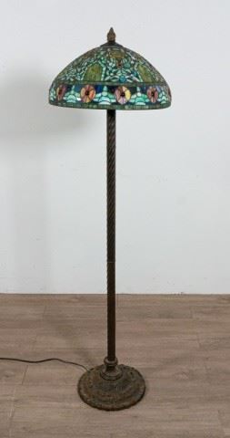374	Tiffany Studios Style Floor Lamp	Tiffany Studios Style floor lamp. American, Early 20th Century. Bronze floral base, twisted stand, floral leaded glass shade. Lamp has not been tested. 65" H x 19" Diameter
