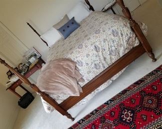 Bedroom #4: Queen 4 poster bed, 2 matching round tables, long chest, yellow cloth chair and older desk/table