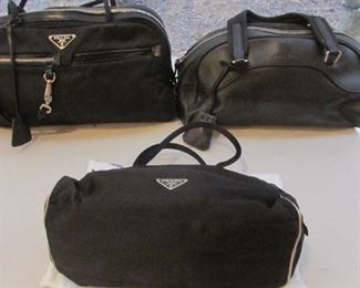 Three Prada handbags