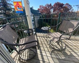 4 pc swivel chair patio set and 2 wrought iron tables.