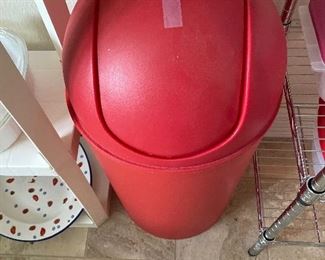 Red plastic garbage can