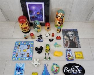 (1) Disney Parks Pin set with 7 pins  (2) Winnie the Pooh Nesting dolls  (16) Misc Disney and Seaworld Magnets  (1) Post card of Cruella  Haunted Mansion Picture by Larry Dotson
