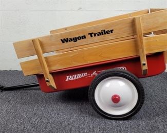Vintage Radio Flyer 2 Wheel Metal Wagon Tow-Behind Trailer with Wood Sides. INCLUDES HITCH to tow behind larger trailer (attach to rear axle).  This little trailer is a discontinued collector item from Radio Flyer item.
