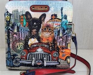Nicole Lee Satchel Studded Purse Dog/Cat Las Vegas Dog / Cat studded on 1 side smooth on the other. Removable strap and purse has 2 sections.