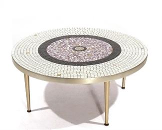 Lot 44 | MID-CENTURY MODERN BRASS & TILE LOW TABLE | Custom-made mosaic tile table with purple, black, and white tiles arranged in concentric circles, all over brass tapering legs; with an Interstate Marble & Tile Co., Inc., Miami, Florida label to underside, table no. 51-36 RND, "Terrific," possibly by Senguso or Sengeso; h. 15 dia. 36 in.
