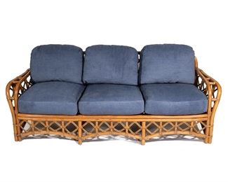 Lot 59 | FICKS REED FAUX BAMBOO & RATTAN SOFA |  With three loose cushions, labeled; h. 30 w. 82 d. 31 in.