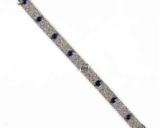 Lot 108 | ANTIQUE DIAMOND & SAPPHIRE BRACELET | Designed as an openwork platinum bracelet with a central approx. 1.5ct diamond [7.1 - 7.3 x 4.6 mm] within a full-cut diamond-encrusted articulating link band and with seven openwork stations each with a half-carat cushion cut sapphire; l. 6-3/4 in., 32.4g; in an antique gilt leather box