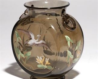 Lot 126 | EMILE GALLE ENAMELED VASE | Olive green ground with dragonfly and crane enameling, with fixed ring handles; h. 6 w. 5 d. 3 in.