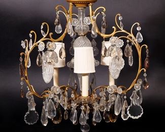 Lot 132 | CRYSTAL & ORMOLU BIRDCAGE-TYPE CHANDELIER | Three arm chandelier with flower form crystals and suspended faceted and smooth crystals of varying shapes, electrified; h. 24 dia. 24 in.