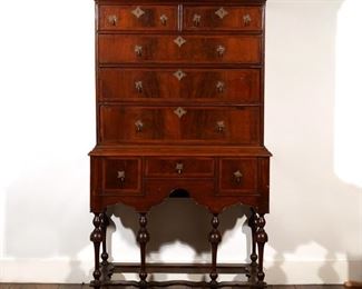Lot 148 | NEW ENGLAND WILLIAM & MARY WALNUT HIGHBOY | Early 18th century, with walnut-veneered cross-banded drawer fronts and cock-beaded drawer openings; h. 69-1/2 w. 39 d. 19-1/2 in.