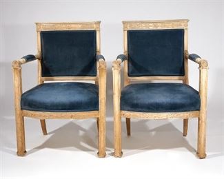 Lot 154 | PAIR 19TH C PAINTED FRENCH EMPIRE CARVED FAUTEIULS | Fauteuil armchairs en cabriolet with anthemion carved crest rail, turned padded armrests with ring turned terminals with recessed carved boss, bowed anthemion carved apron, resting on paneled legs with hoof feet; h. 35 w. 24 d. 23 in.