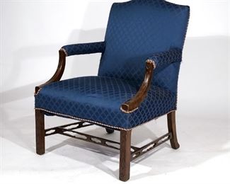Lot 155 | GEORGE III MAHOGANY LIBRARY CHAIR | Circa early 19th century, having blind fretwork carving on arms and front legs, open work stretcher; h. 38 w. 28 d. 36 in.