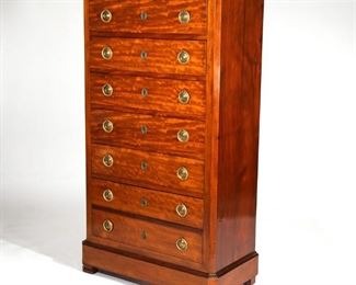Lot 158 | CONTINENTAL NEOCLASSICAL SEMAINIER | Circa 1840, having ring pulls and locks on each drawer, the lowest drawer is a double, six drawers in total; h. 61-3/4 w. 35 d. 17-1/2 in.