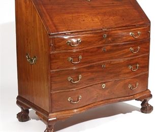 Lot 159 | 18TH C. CHIPPENDALE REVERSE SERPENTINE DESK | Slant lid desk with a reverse serpentine front and fitted interior over four graduated full-width drawers resting on ball and claw feet, with side carrying handles; h. 43-1/2 w. 46 d. 24 in.