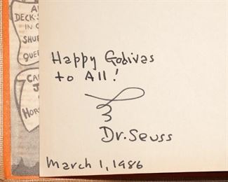 Lot 177 | [SIGNED] DR. SEUSS, THE SEVEN LADY GODIVAS | First edition, quarto, tan buckram cloth stamped in maroon with illustrated endpapers, interior with bookplate "From The Library of Cas and Middie Speare" Random House / Duenewald, 1939; opposite frontispage inscribed "Happy Godivas to All" and signed by Dr. Seuss, dated March 1, 1986; h. 10-1/4 w. 7-3/4 in. | One of only a few books written by Dr. Seuss for adults; the owner of this copy met Dr. Seuss at a bookstore in Manhattan and brought the book for him to sign. He said he "had not seen one of these in forty years." One of only a few books written by Dr. Seuss for adults; the owner of this copy met Dr. Seuss at a bookstore in Manhattan and brought the book for him to sign. He said he "had not seen one of these in forty years."