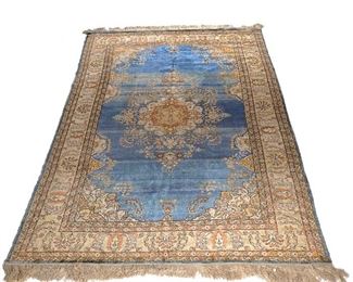 Lot 229 | HEREKE SILK RUG | Having an ornate central medallion on a blue field within borders of flower and leaf motifs
h. 8 ft. 5 in. w. 5 ft. 3 in.