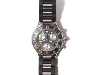 loT 289 | CARTIER CHRONOGRAPH 21 WRISTWATCH | Having a stainless steel case on a rubberized band, black patterned dial with luminescent hour markers and hands, three subdials, sapphire cabochon crown, and quartz movement