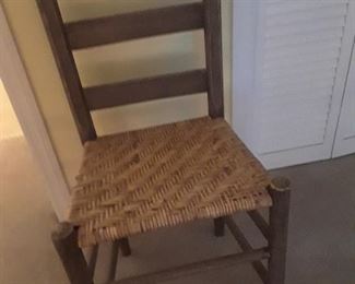 Antique straight back farm chair with woven seat