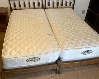Wooden twin beds with Beautyrest bedding 