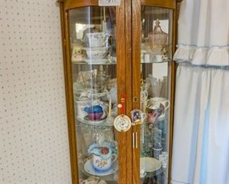Curved glass curio with plenty of collectibles