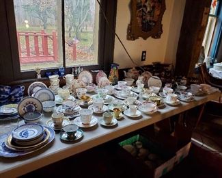 Many cups and saucers, creamers and tea pots