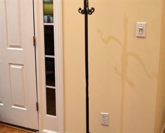 Unique coat rack made of iron and adorned with snakes.