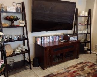 Curved Samsung Smart TV and two ladder shelves with entertainment center
