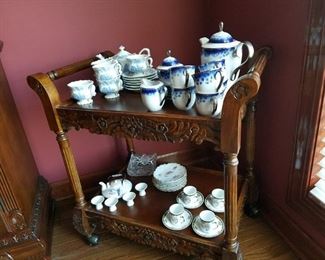 Rolling tea cart server and nice selection of serving pieces.