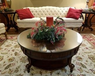 Round coffee table has custom glass protective top and nice Christmas centerpiece.