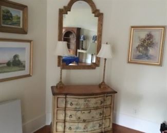 Painted chest, buffet lamps, artwork and a mirror