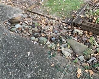 THE YARD IS LOADED WITH ROCKS.  