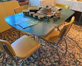 green melamine and chrome drop-leaf dinette table and four yellow/gold chairs 