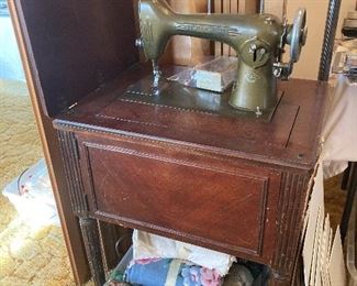 vintage New Home sewing machine in cabinet