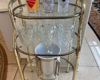 Cute little glass shelved stand.  Kentucky Derby glasses.