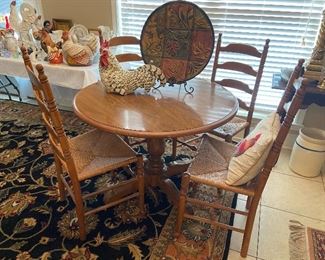 Beautiful pedestal table with 4 ladder back chairs.
