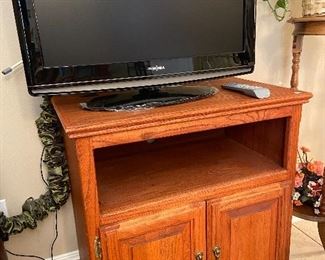 Solid wood stand on casters.  Great for TV or microwave.