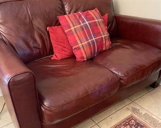 Beautiful burgundy leather love seat.