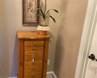 Jewelry armoire with sides that open and top opens to a standing mirror.