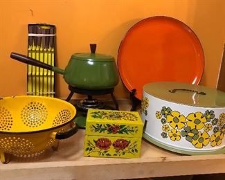 Colorful kitchen: yellow enamel colander, green fondue pot, recipe box & flower power cake carrier 
