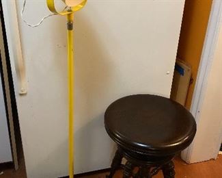 This photo sums up how eclectic this sale is: Mid-century yellow floor lamp (45” tall), antique piano stool with glass ball & claw feet (adjustable height) 