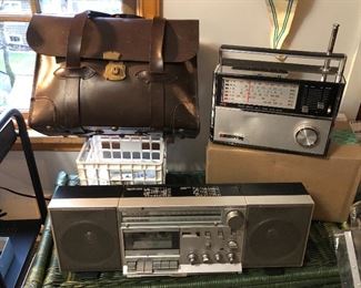 Vintage military leather briefcase, Craftsman multi-band AC-DC radio, GE AM/FM cassette music system

