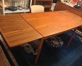 Teak dining table with both leaves extended - as shown 84” long. You can have one or both leaves extended. 